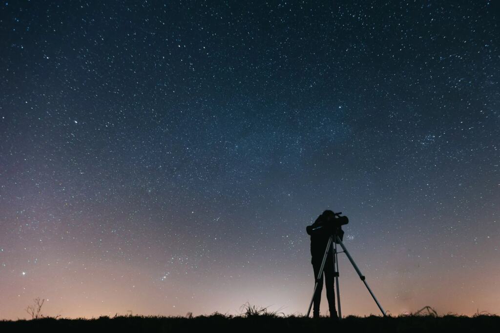 Telescope pointed at a starry night sky